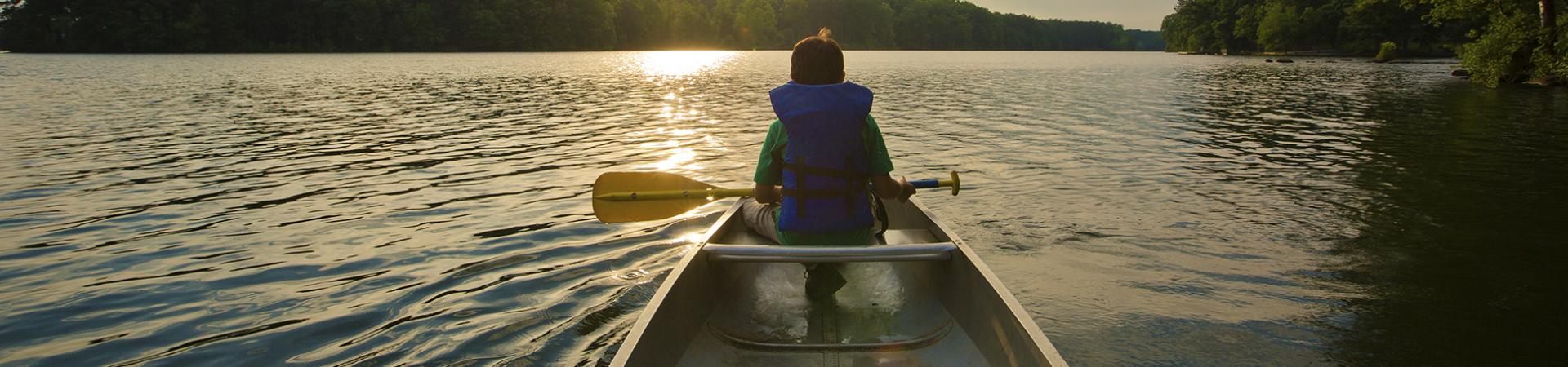 Boy in kayak with paddle